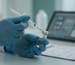 Gloved hands preparing an injection, illustrating precision for CPT code for injections.
